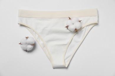 Stylish women's underwear and cotton flowers on white background, flat lay