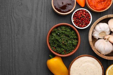 Photo of Different fresh marinades in bowls and ingredients on grey wooden table, flat lay. Space for text