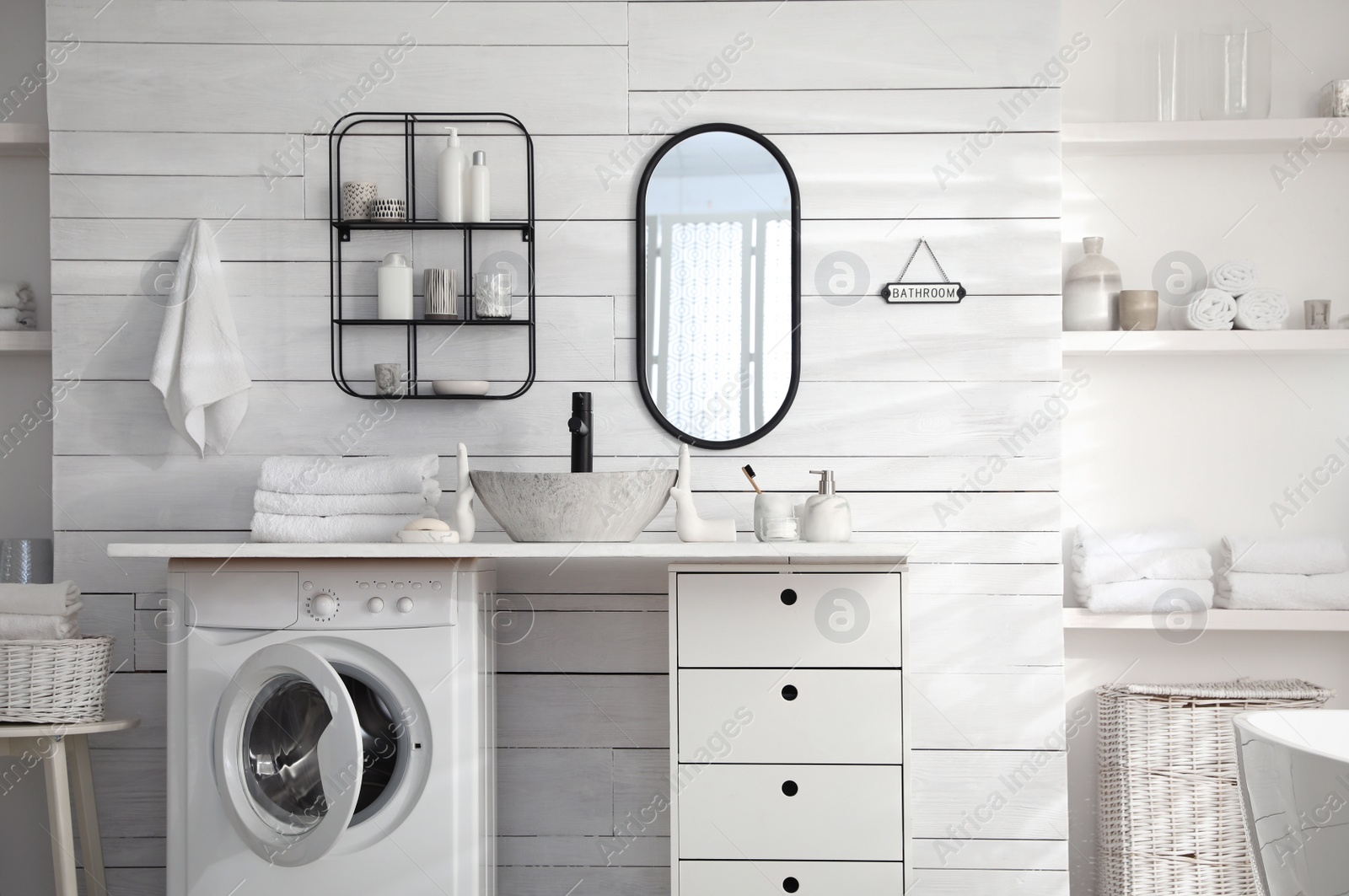 Photo of Stylish bathroom interior with modern washing machine