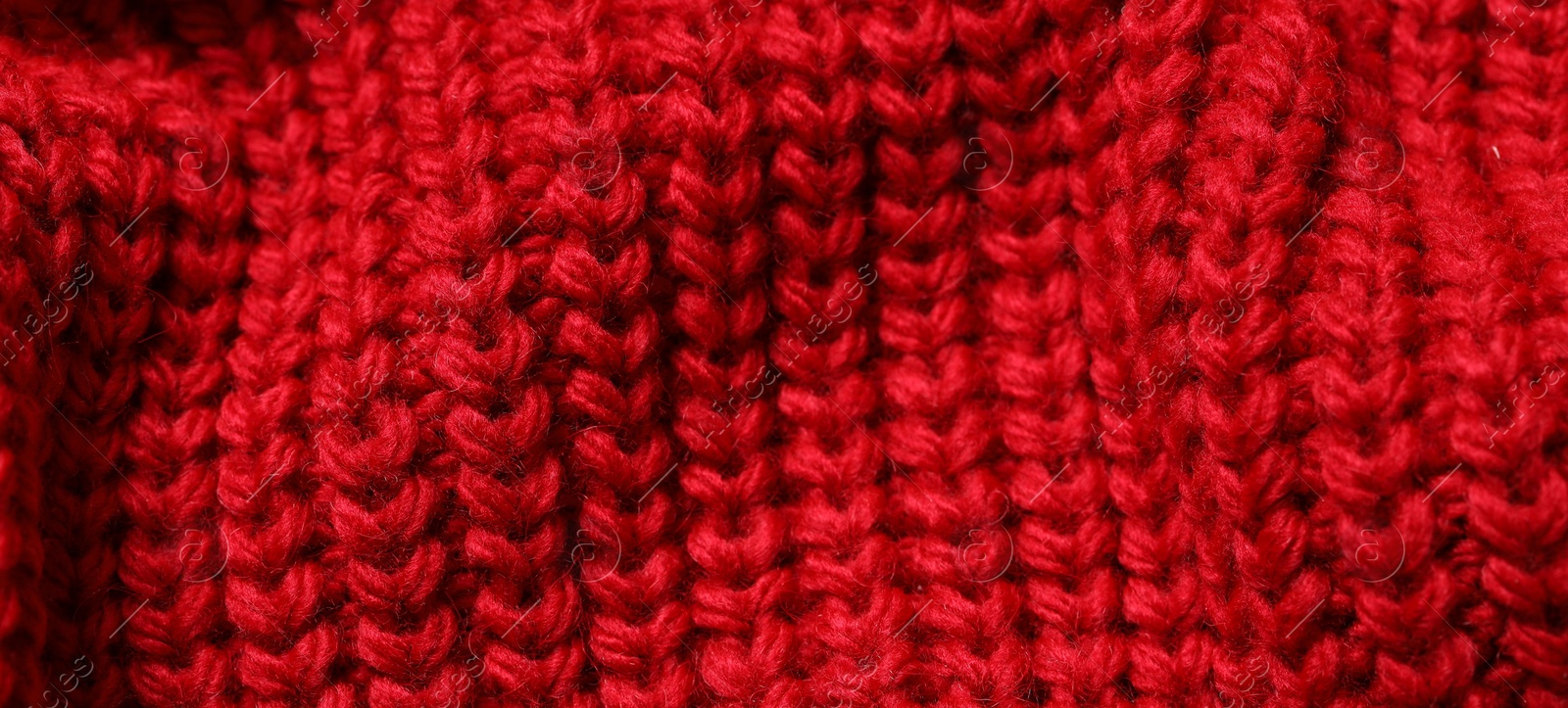 Photo of Texture of soft red knitted fabric as background, closeup