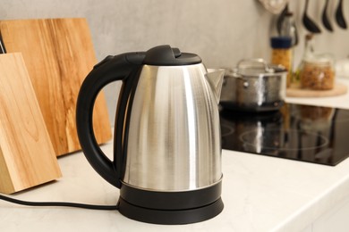 Photo of Modern electric kettle on counter in kitchen