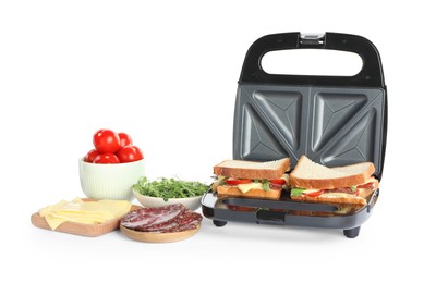 Modern grill maker with tasty sandwiches and ingredients on white background