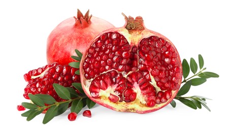 Fresh pomegranates and branches isolated on white