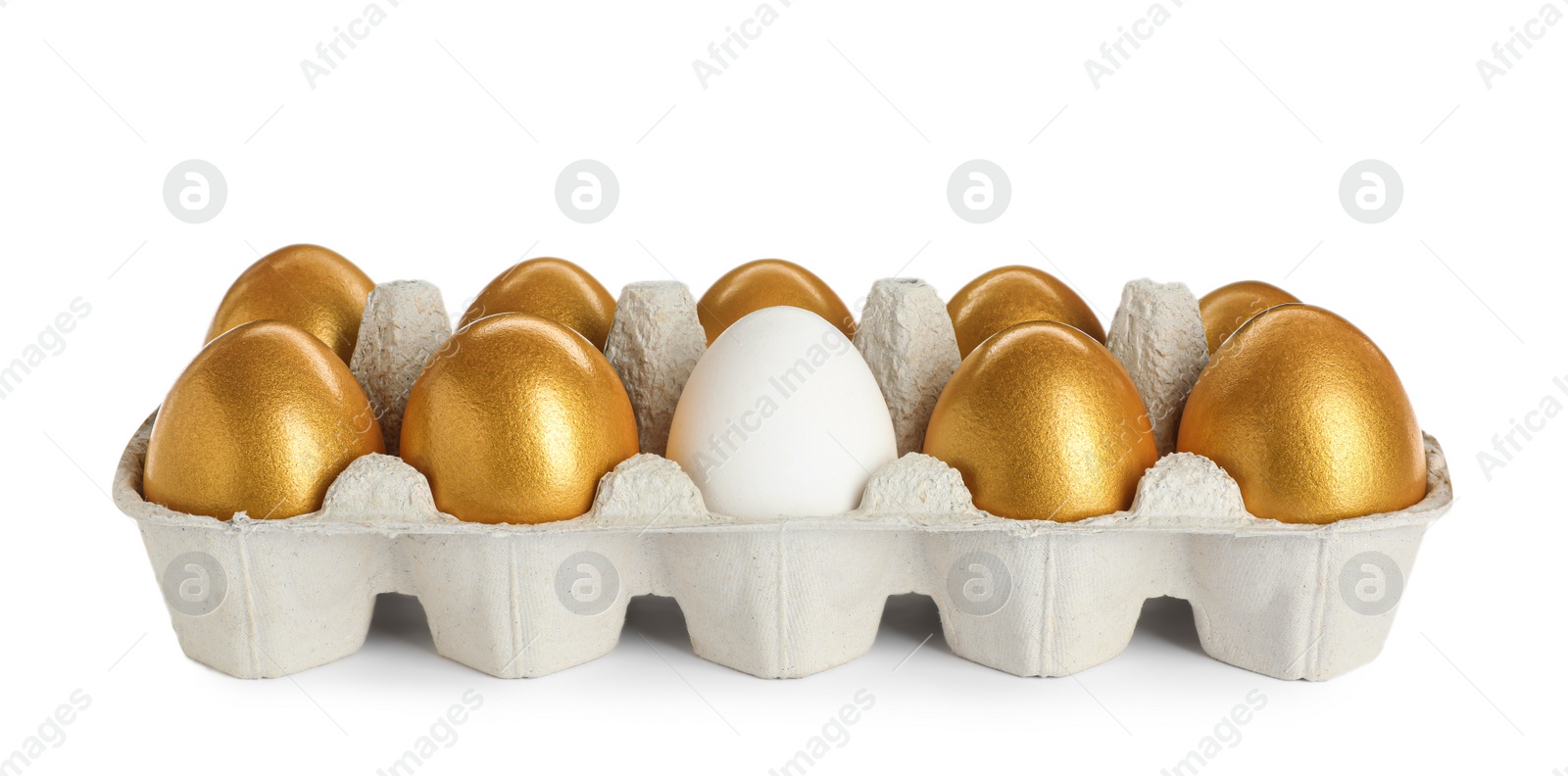 Photo of Carton with golden eggs and ordinary one on white background