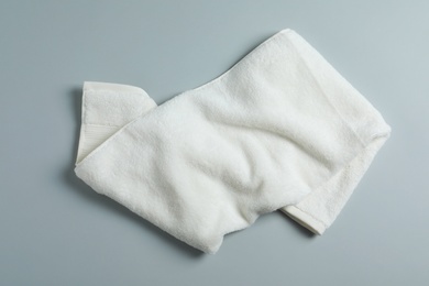 Soft towel on light background, top view