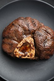 Photo of Piece of tasty grilled beef meat on plate, top view