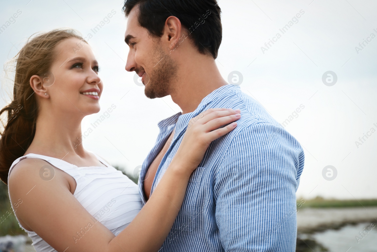 Photo of Happy young couple spending time at sea beach