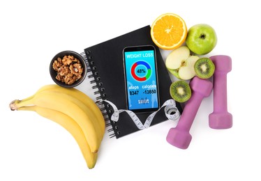 Photo of Smartphone with weight loss program, dumbbells and different products on white background, top view