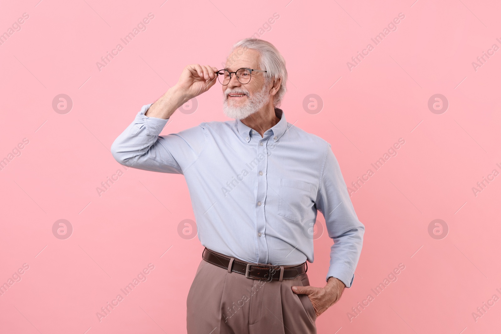 Photo of Portrait of stylish grandpa with glasses on pink background