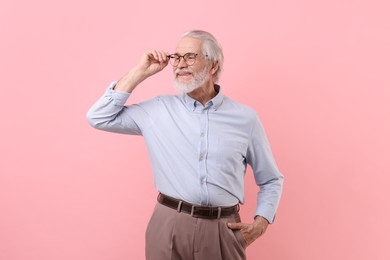 Photo of Portrait of stylish grandpa with glasses on pink background