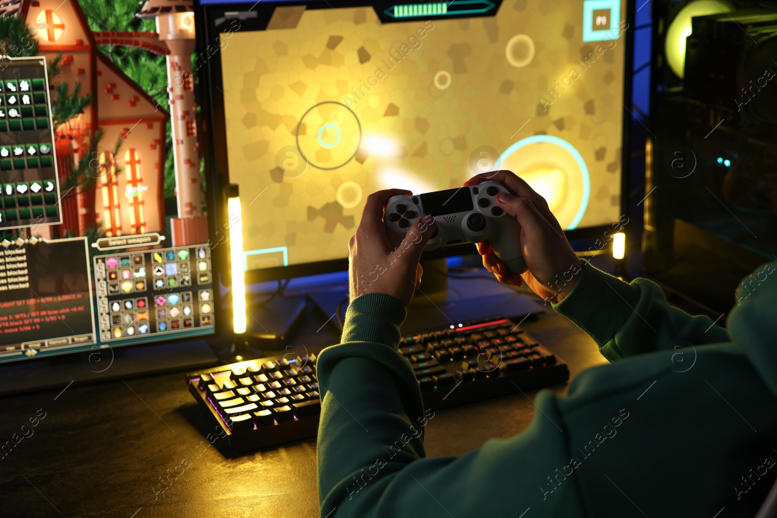 Photo of Man playing video games with controller at table indoors, closeup