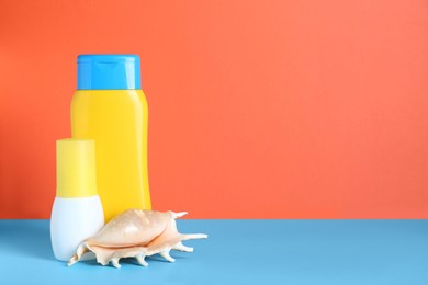 Different suntan products and seashell on color background. Space for text