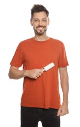 Photo of Handsome man using lint roller on white background