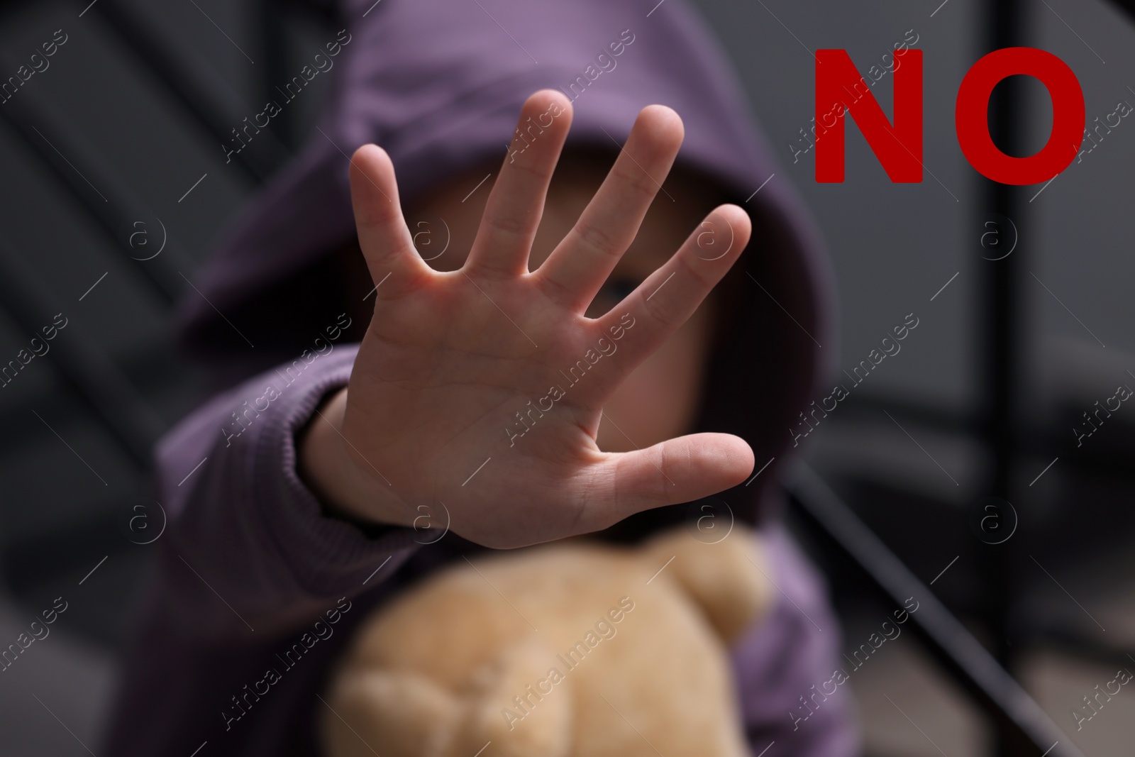 Image of No child abuse. Boy doing stop gesture indoors, selective focus