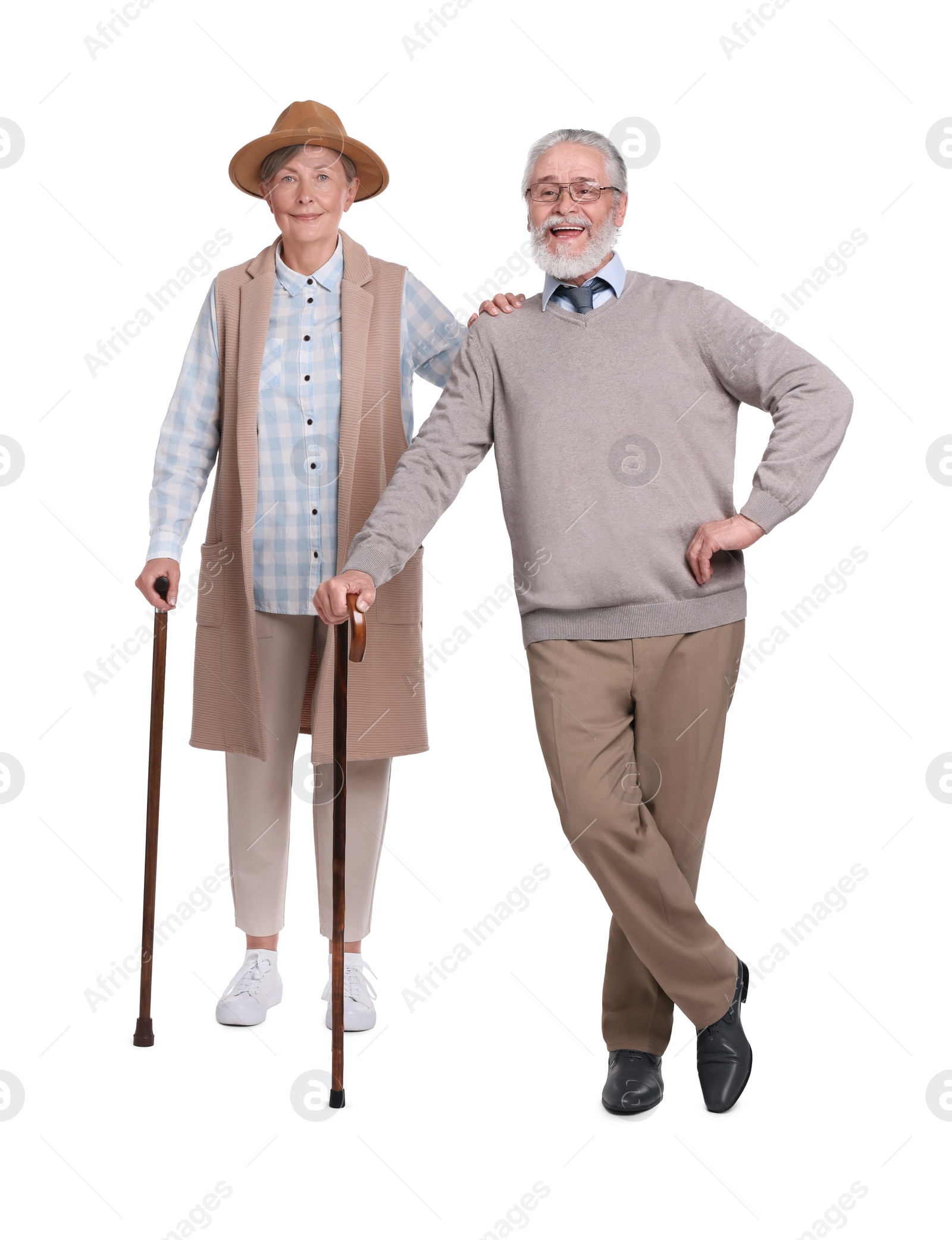 Photo of Senior man and woman with walking canes on white background