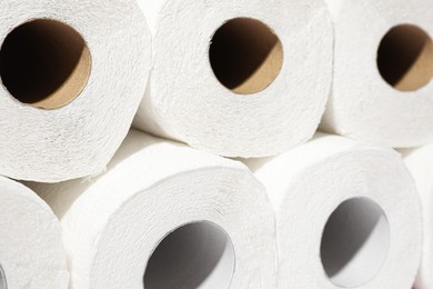 Photo of Many rolls of paper towels as background, closeup