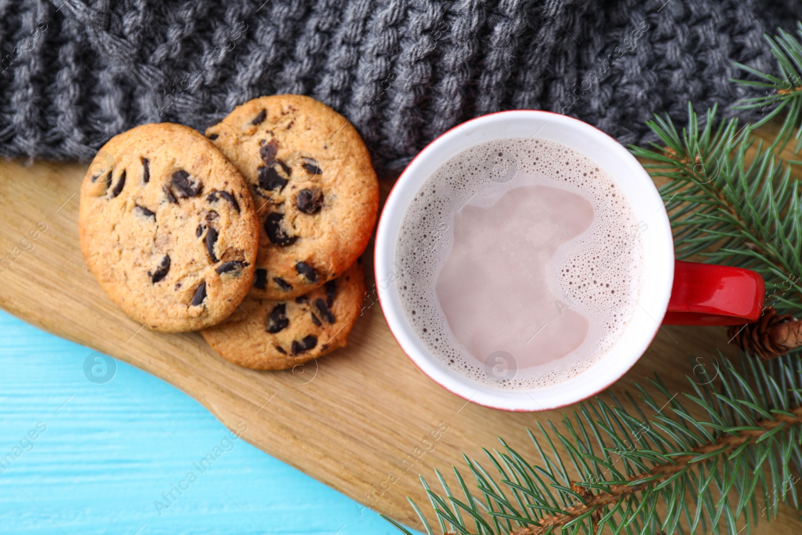 Photo of Flat lay composition with cup of tasty cocoa on blue wooden table