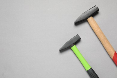 Photo of Two hammers on grey background, top view. Space for text