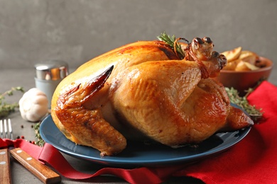 Photo of Platter of cooked turkey with rosemary served on table