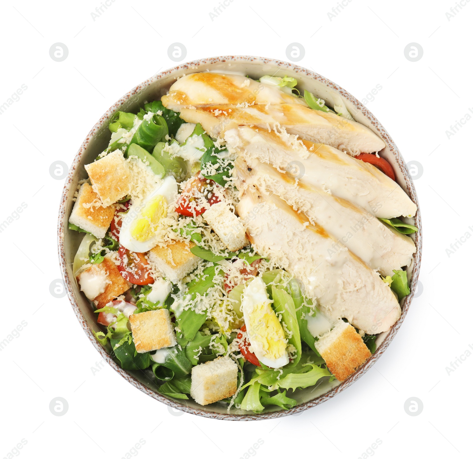 Photo of Delicious Caesar salad in bowl isolated on white, top view