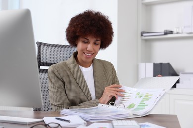 Professional accountant working at wooden desk in office