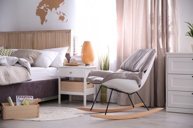 Photo of Modern eco style interior with wooden crates and comfortable bed