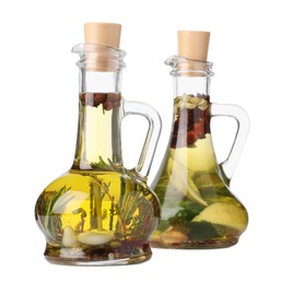 Photo of Glass jugs of cooking oils with spices and herbs on white background