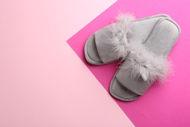 Photo of Pair of stylish soft slippers on color background, flat lay. Space for text