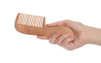 Woman holding wooden hair comb on white background, closeup