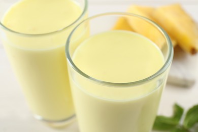 Photo of Tasty fresh pineapple smoothie on table, closeup