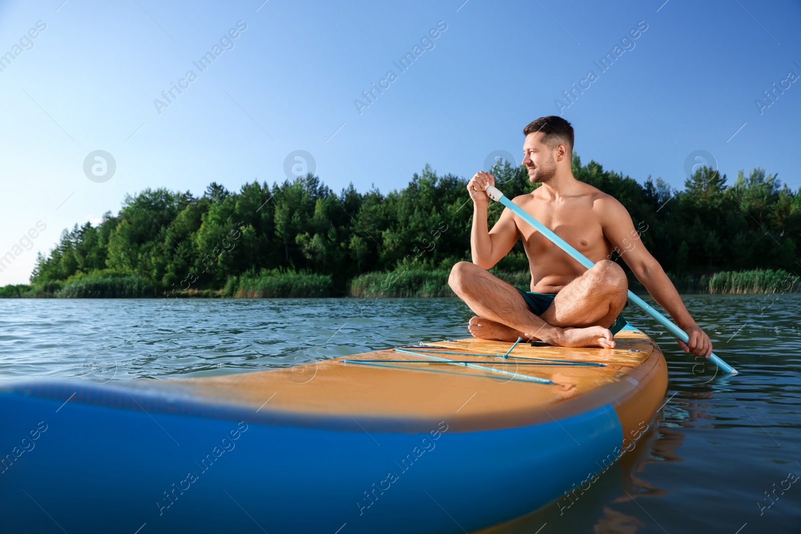 Photo of Man paddle boarding on SUP board in river