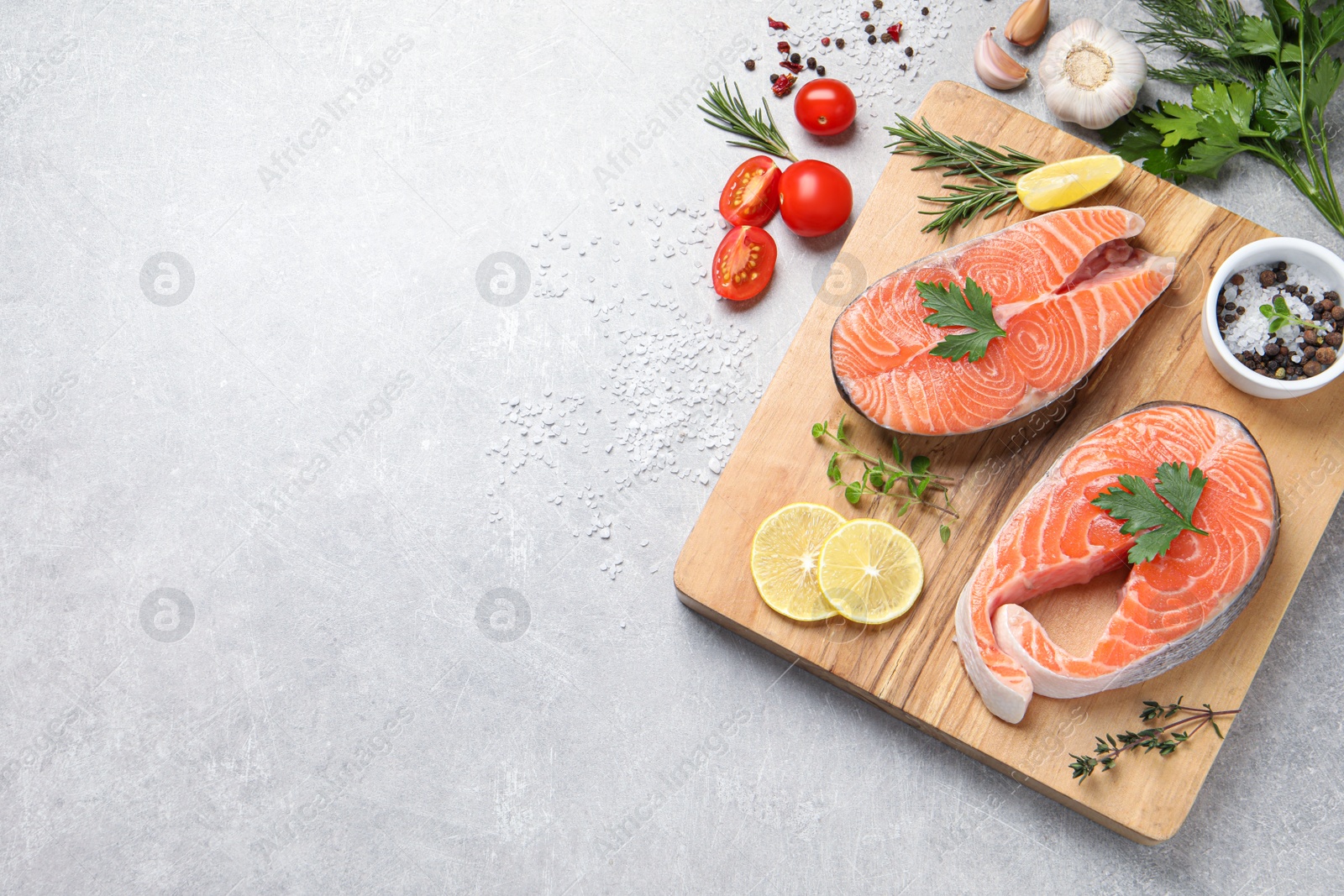 Photo of Fresh salmon and ingredients for marinade on light grey table, flat lay. Space for text