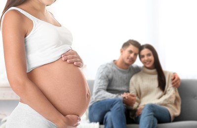 Image of Surrogate mother and intended parents in room