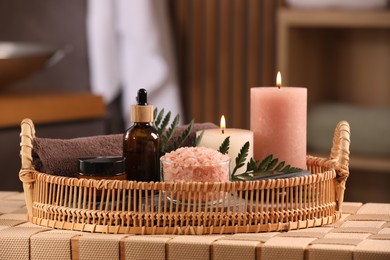 Beautiful composition with different spa products on wicker bench indoors