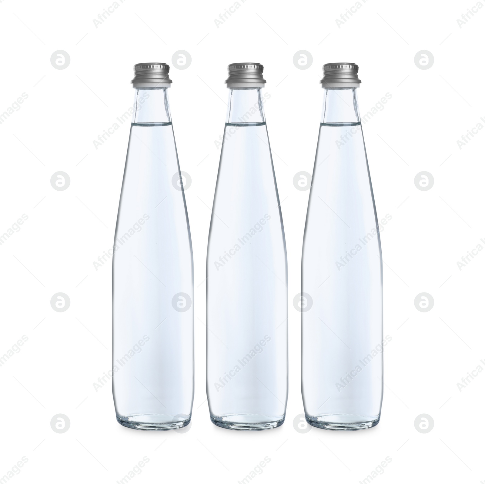 Photo of Glass bottles with soda water on white background