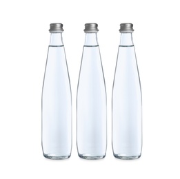 Glass bottles with soda water on white background