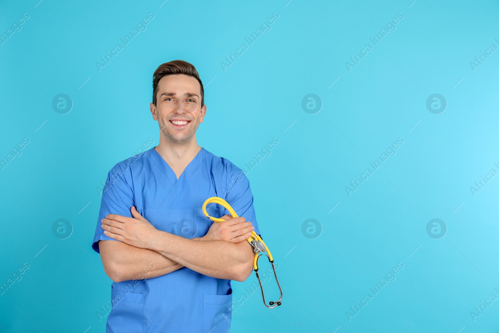 Photo of Portrait of medical assistant with stethoscope on color background. Space for text