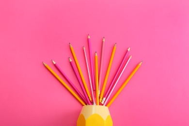 Photo of Flat lay composition with colorful pencils on pink background