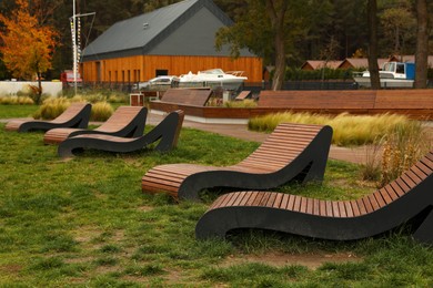 Photo of Recreation area with wooden sunbeds for rent outdoors. Real estate