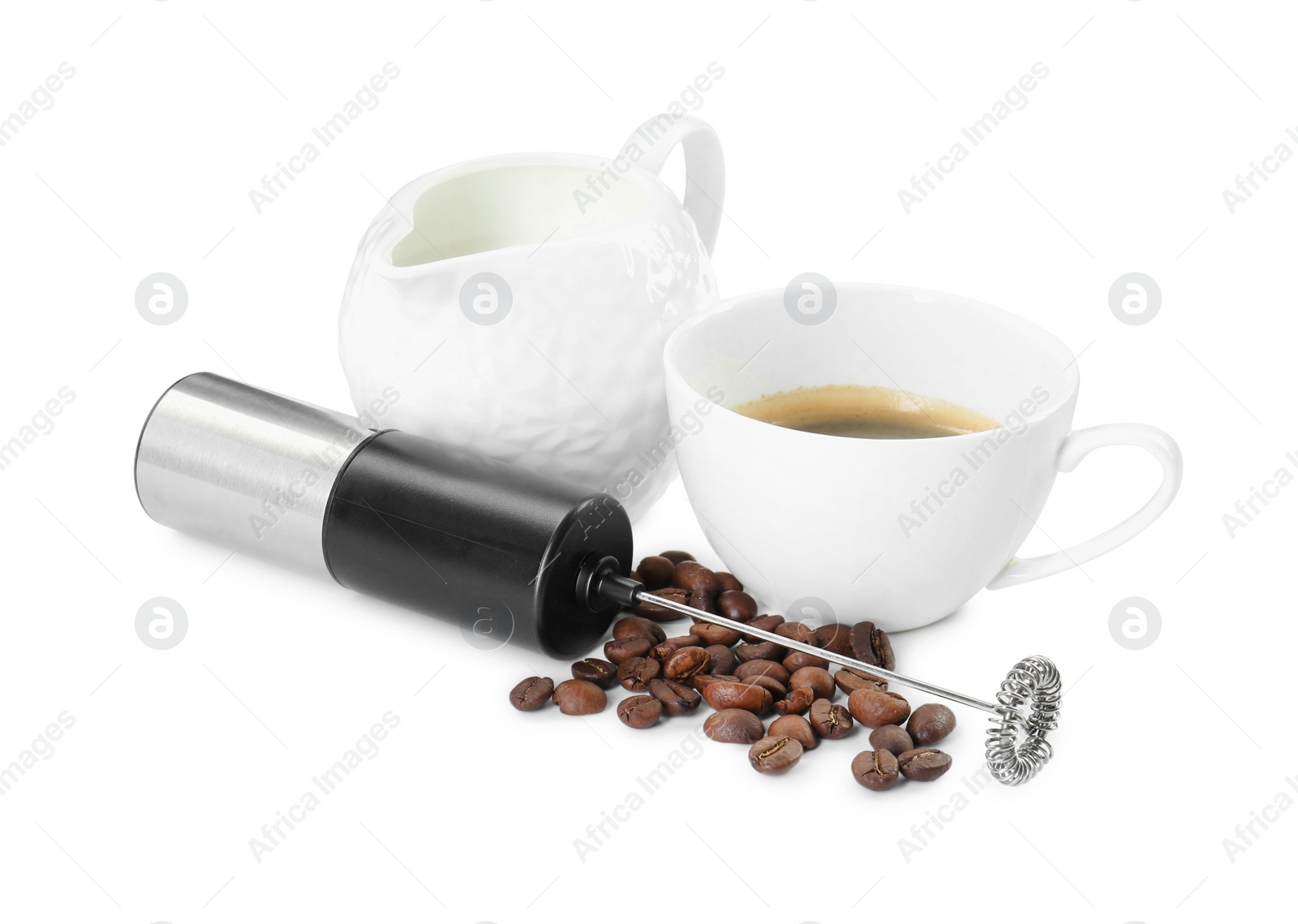 Photo of Mini mixer (milk frother), cup, coffee beans and pitcher isolated on white