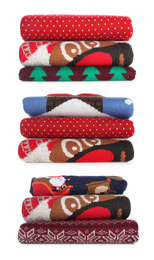 Set with stacks of folded Christmas sweaters on white background