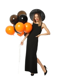 Photo of Beautiful woman wearing witch costume with balloons for Halloween party on white background