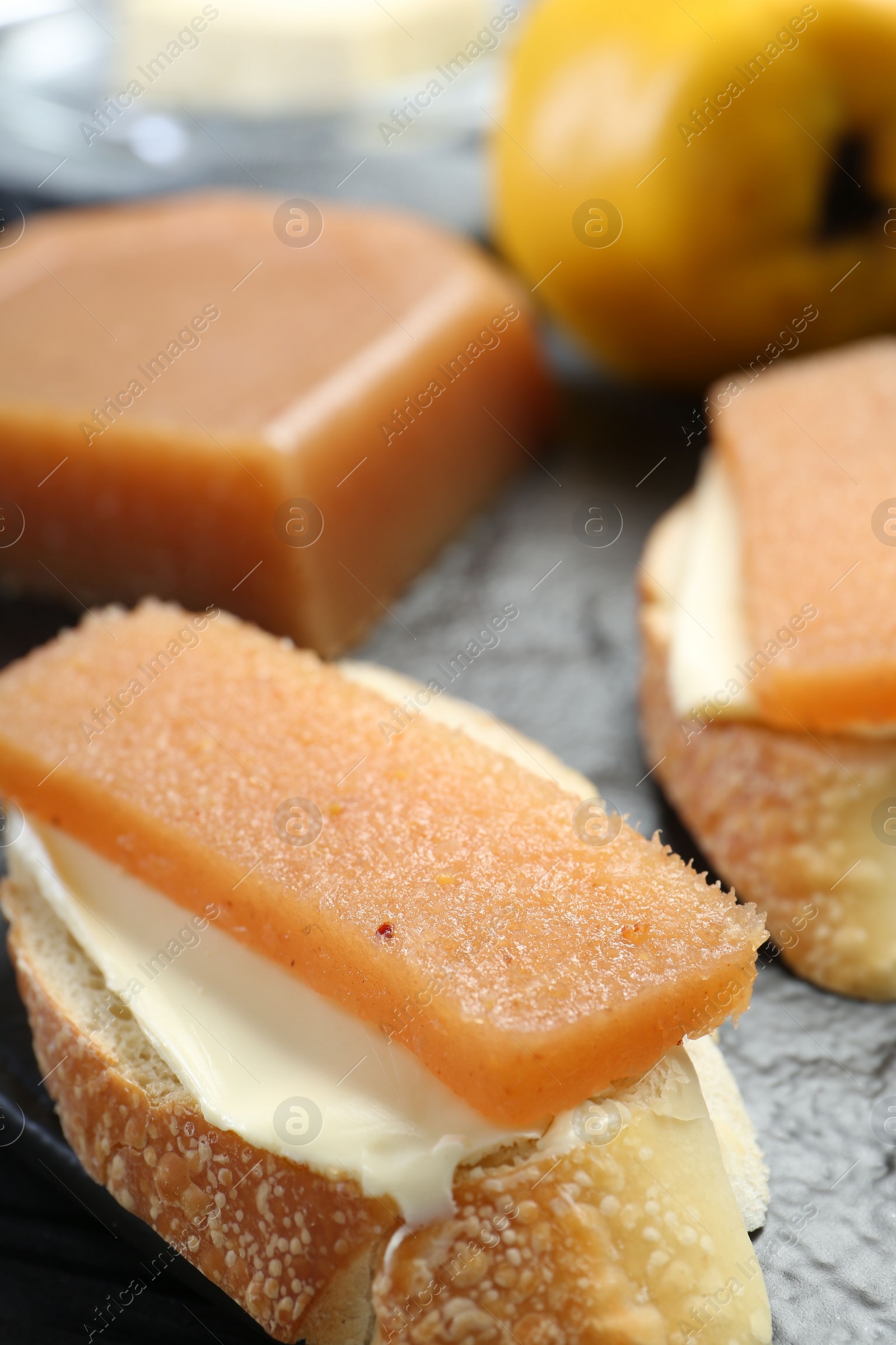 Photo of Tasty sandwiches with quince paste on board, closeup