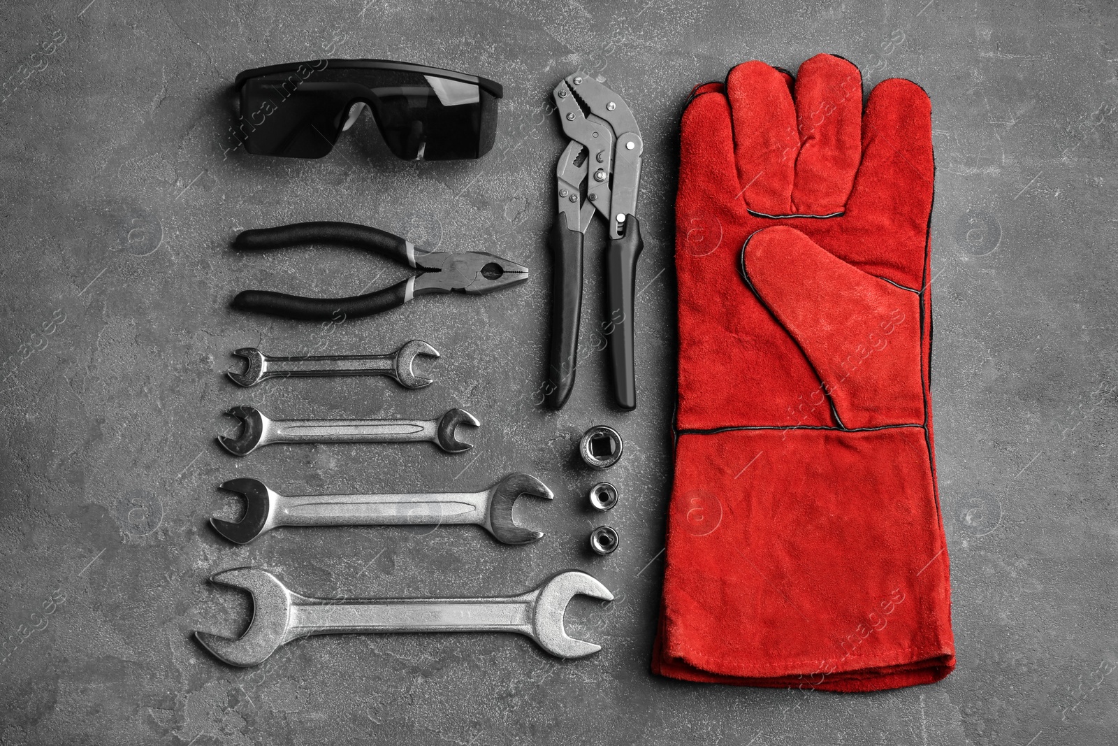 Photo of Flat lay composition with different construction tools on grey background