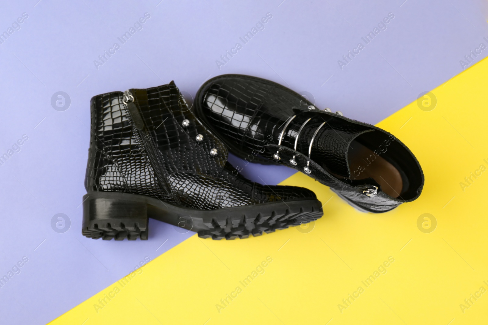 Photo of Pair of stylish ankle boots on color background, top view