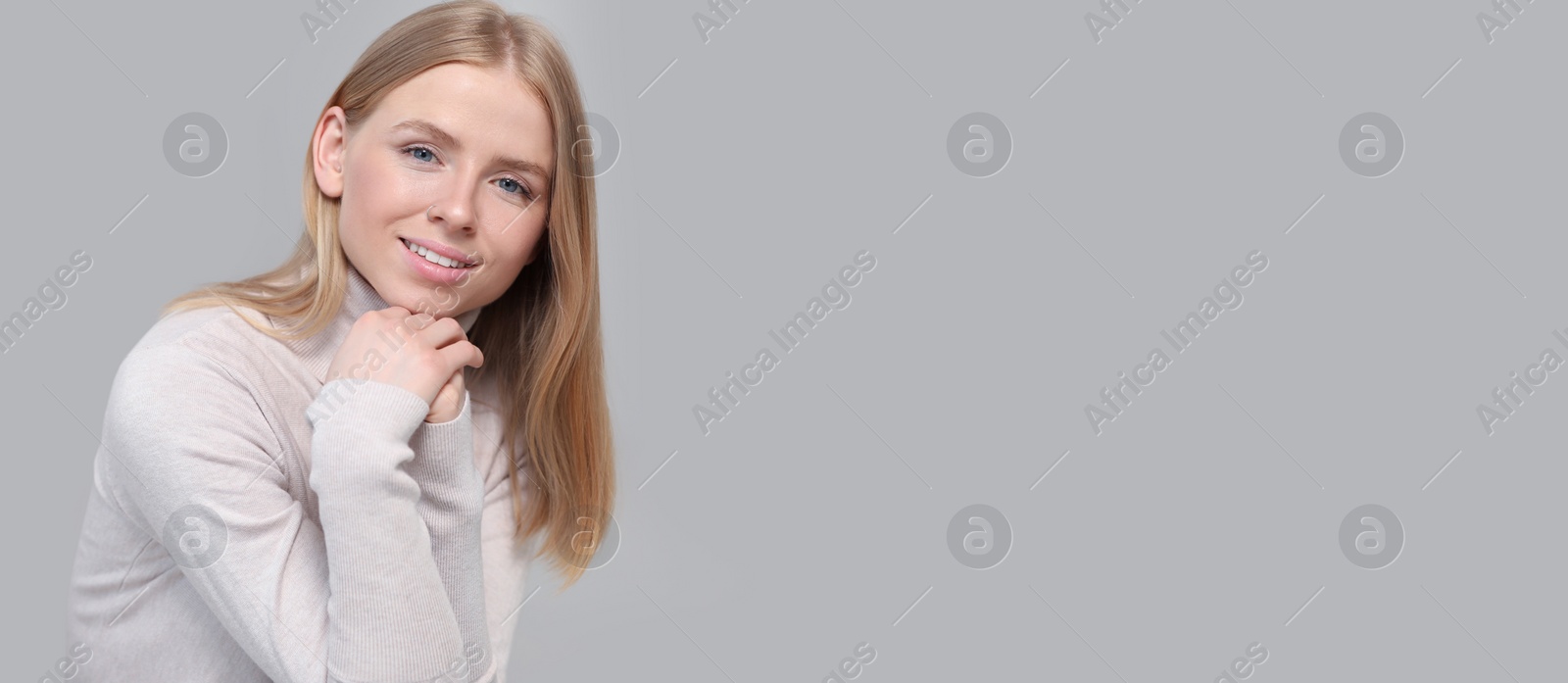 Image of Portrait of beautiful young woman on light grey background. Banner design with space for text