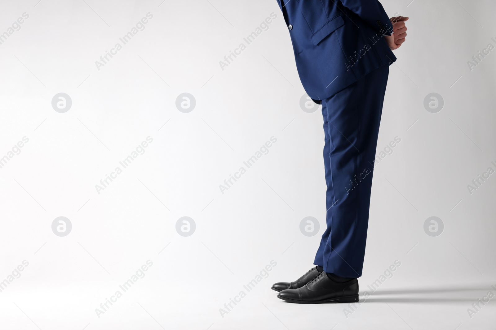 Photo of Businessman in leather shoes on white background, closeup