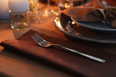 Beautiful setting with cutlery and plates on table