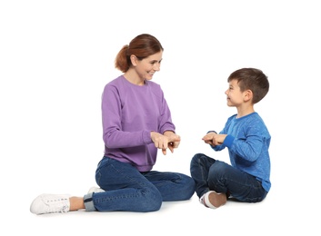 Photo of Hearing impaired mother and her child talking with help of sign language on white background