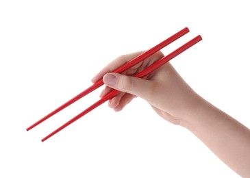 Photo of Woman holding pair of red chopsticks on white background, closeup